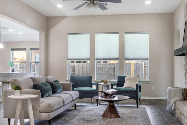 living area featuring a ceiling fan, recessed lighting, and wood finished floors