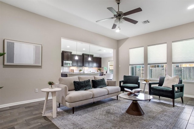 living area featuring dark wood finished floors, a ceiling fan, baseboards, recessed lighting, and visible vents