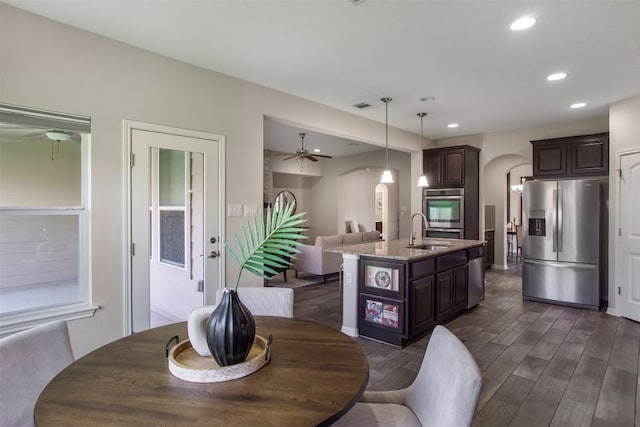 dining space featuring ceiling fan, arched walkways, recessed lighting, dark wood-type flooring, and visible vents