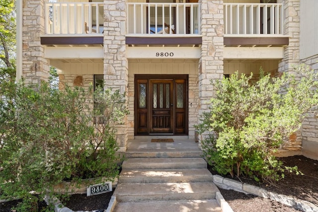 9800 Knotty Pine Cv, Austin, TX 78750 - doorway to property featuring a balcony and stone siding