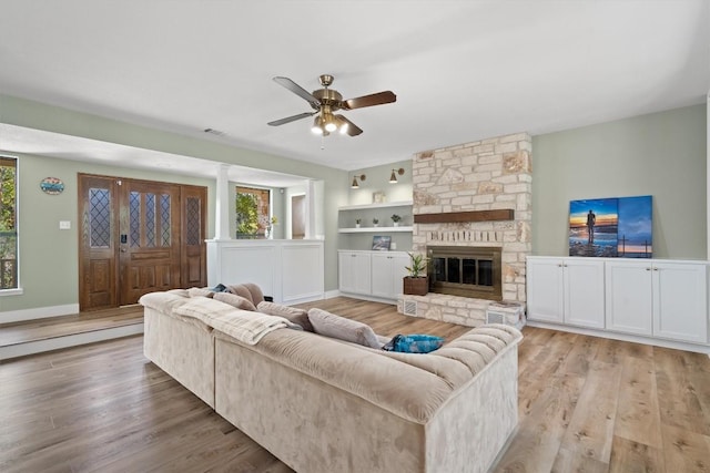 9800 Knotty Pine Cv, Austin, TX 78750 - living area with baseboards, ceiling fan, visible vents, and light wood-style flooring