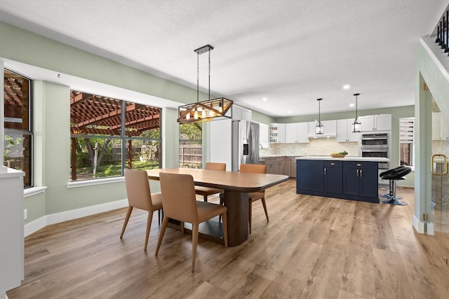 9800 Knotty Pine Cv, Austin, TX 78750 - dining room with recessed lighting, baseboards, light wood finished floors, and a chandelier
