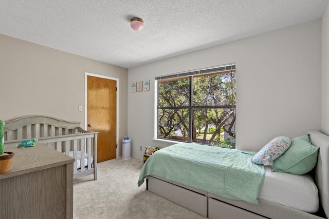 9800 Knotty Pine Cv, Austin, TX 78750 - bedroom featuring a textured ceiling and light colored carpet