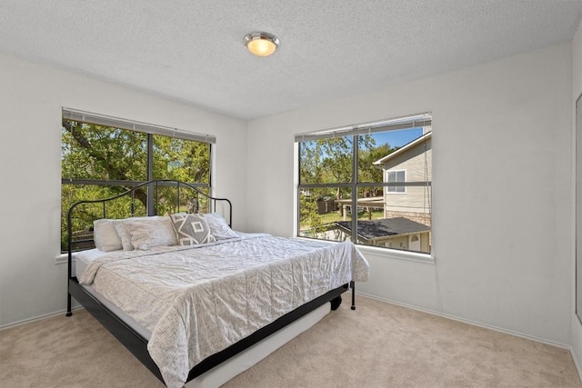 9800 Knotty Pine Cv, Austin, TX 78750 - bedroom featuring a textured ceiling, baseboards, and carpet