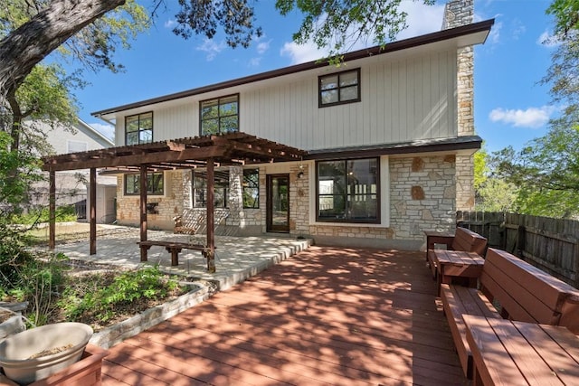 9800 Knotty Pine Cv, Austin, TX 78750 - rear view of property with a chimney, a deck, fence, a pergola, and stone siding