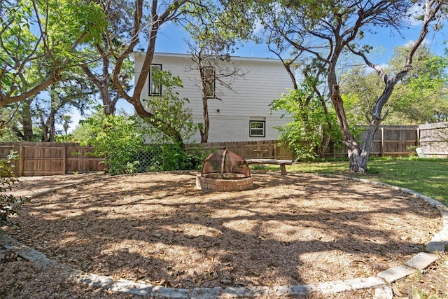 9800 Knotty Pine Cv, Austin, TX 78750 - back of house featuring a fenced backyard and an outdoor fire pit