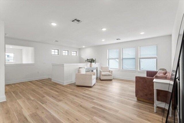 8401 Hubble Walk, Austin, TX 78744 - living area with baseboards, light wood-style flooring, and recessed lighting
