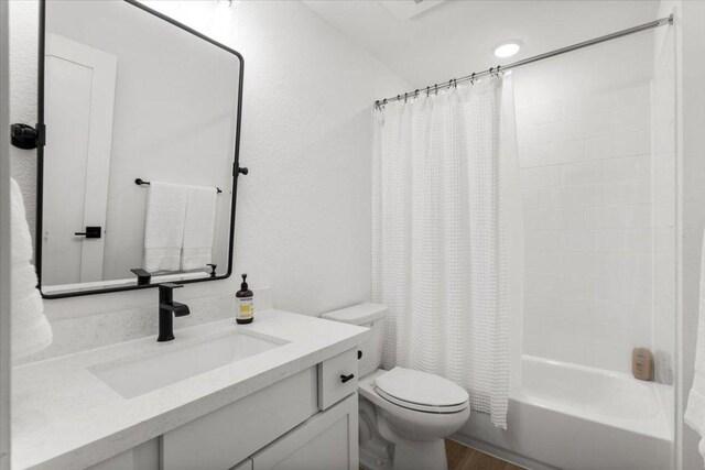 8401 Hubble Walk, Austin, TX 78744 - bathroom featuring toilet, vanity, shower / bathtub combination with curtain, and wood finished floors
