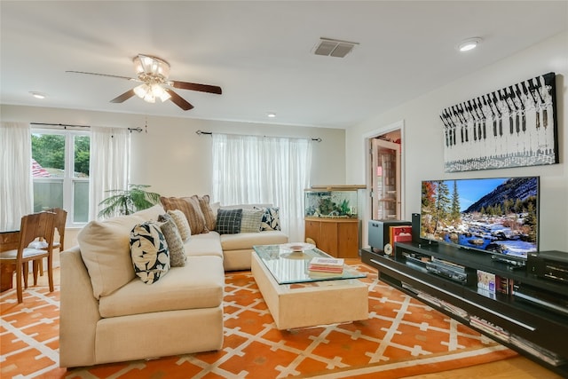 living area featuring ceiling fan, recessed lighting, and visible vents