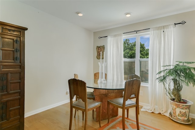 dining room with light wood-style floors and baseboards