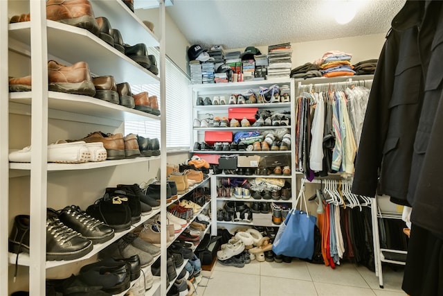 walk in closet with tile patterned floors