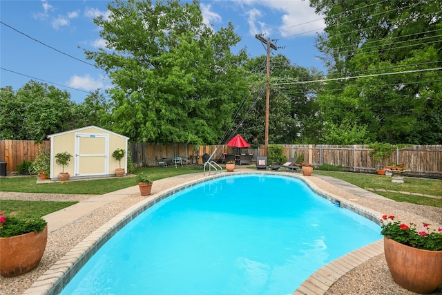 view of pool with a shed, a fenced backyard, a fenced in pool, an outdoor structure, and a yard