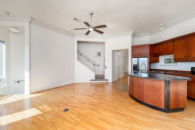 5310 Scenic View Dr, Austin, TX 78746 - kitchen featuring stainless steel fridge with ice dispenser, ceiling fan, light wood-style flooring, crown molding, and a center island with sink