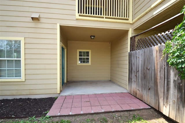 entrance to property featuring fence
