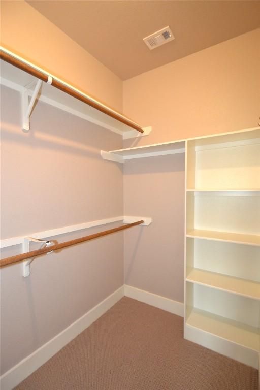 walk in closet with carpet flooring and visible vents