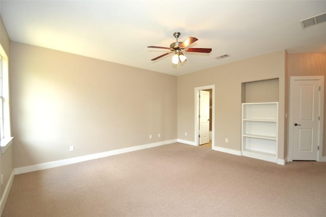 unfurnished bedroom featuring visible vents, a ceiling fan, baseboards, and carpet floors