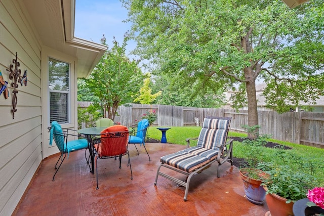 view of patio featuring outdoor dining area and a fenced backyard