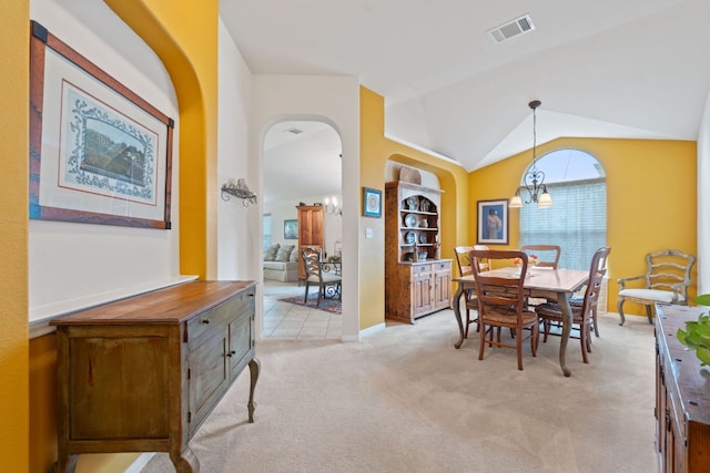 1720 Woodvista Pl, Round Rock, TX 78665 - dining space featuring arched walkways, light colored carpet, lofted ceiling, a chandelier, and baseboards
