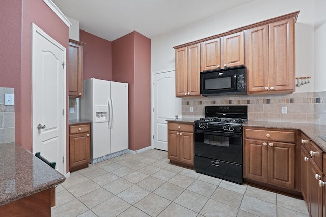 1720 Woodvista Pl, Round Rock, TX 78665 - kitchen with black appliances, decorative backsplash, stone counters, and light tile patterned floors