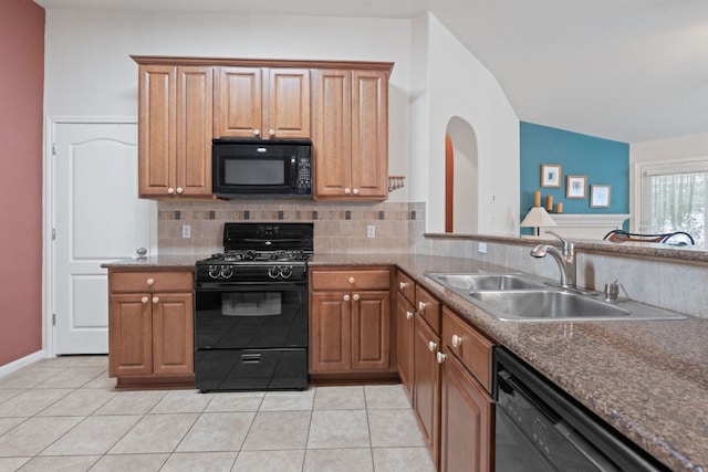 1720 Woodvista Pl, Round Rock, TX 78665 - kitchen featuring black appliances, a sink, decorative backsplash, light tile patterned floors, and brown cabinetry