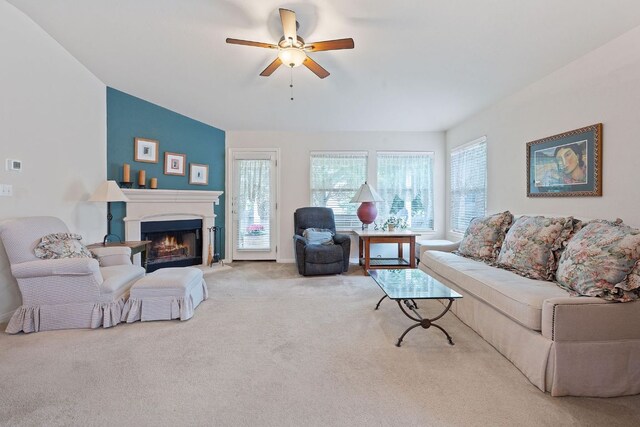 1720 Woodvista Pl, Round Rock, TX 78665 - living area featuring plenty of natural light, light carpet, a lit fireplace, and a ceiling fan