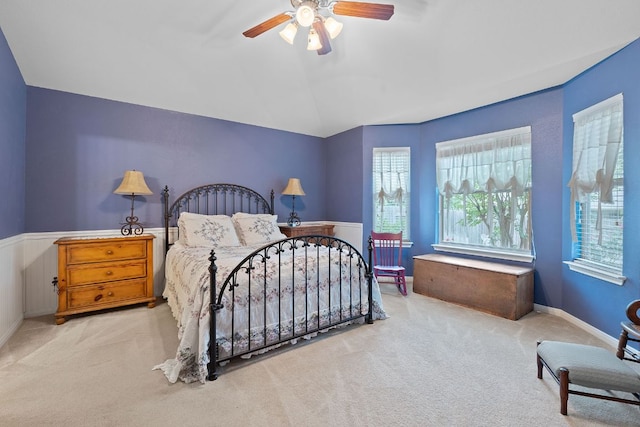 1720 Woodvista Pl, Round Rock, TX 78665 - bedroom featuring carpet floors, ceiling fan, vaulted ceiling, and a wainscoted wall