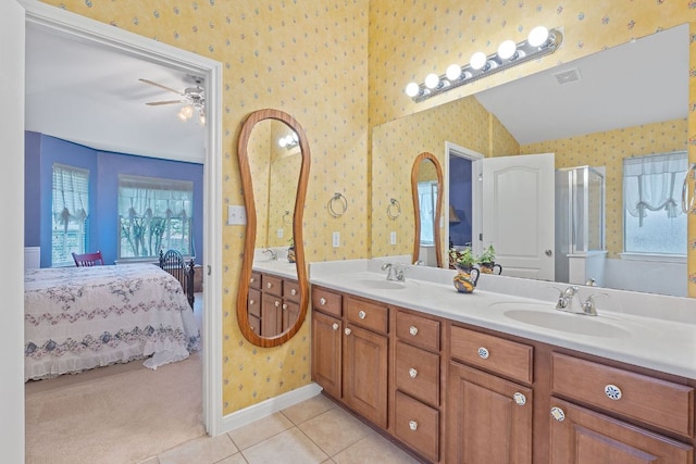 bathroom with wallpapered walls, a sink, and ensuite bath