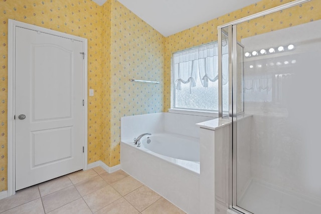 bathroom with baseboards, a shower stall, wallpapered walls, and a garden tub