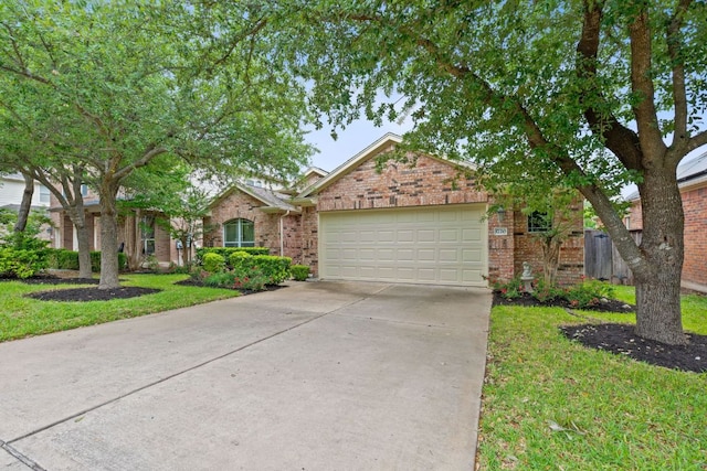 single story home with brick siding, an attached garage, driveway, and a front yard