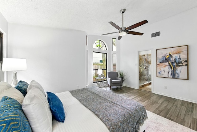 7419 Dallas Dr, Austin, TX 78729 - bedroom featuring wood finished floors, a textured ceiling, connected bathroom, baseboards, and ceiling fan