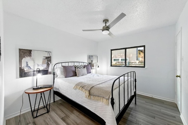 7419 Dallas Dr, Austin, TX 78729 - bedroom with a textured ceiling, wood finished floors, baseboards, and ceiling fan