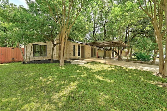 7419 Dallas Dr, Austin, TX 78729 - back of property featuring brick siding, driveway, and a carport