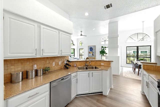 7419 Dallas Dr, Austin, TX 78729 - kitchen featuring dishwasher, a sink, ceiling fan, a peninsula, and white cabinets