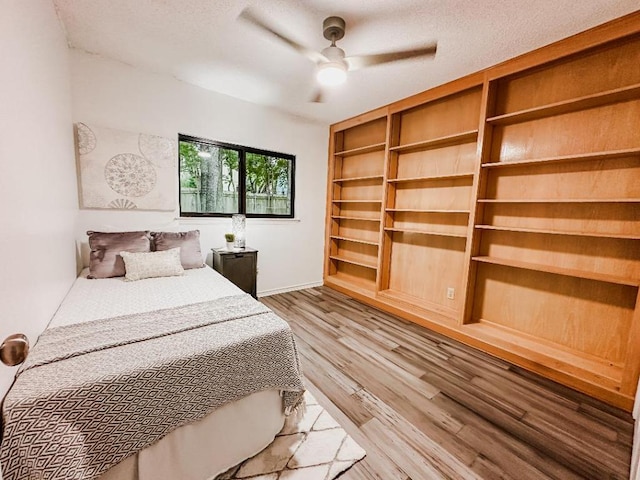 7419 Dallas Dr, Austin, TX 78729 - bedroom featuring light wood-style floors, baseboards, and ceiling fan