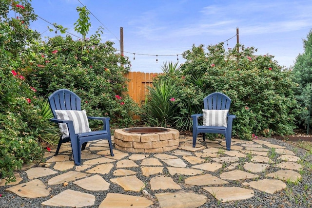 view of patio / terrace with fence and an outdoor fire pit