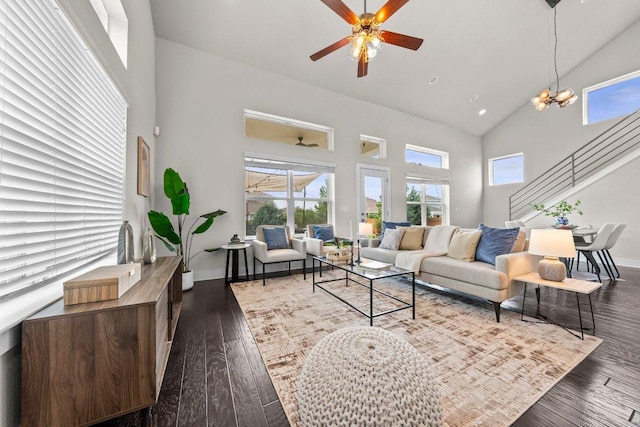 living room with baseboards, a ceiling fan, wood finished floors, and high vaulted ceiling