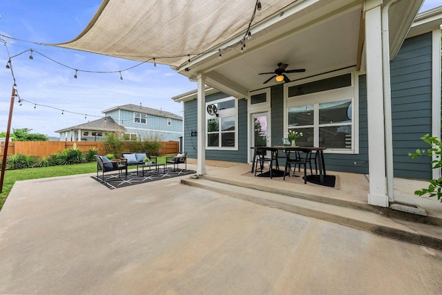 view of patio / terrace featuring fence, outdoor dining space, ceiling fan, and an outdoor living space