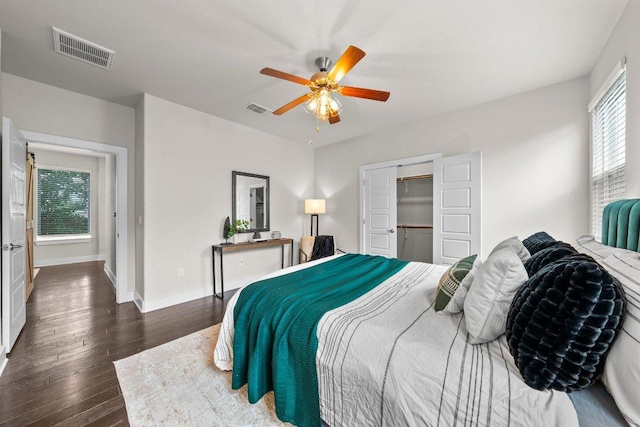 bedroom featuring baseboards, a ceiling fan, dark wood-style flooring, and visible vents