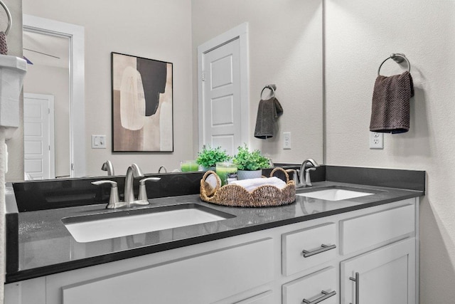 bathroom with a sink and double vanity