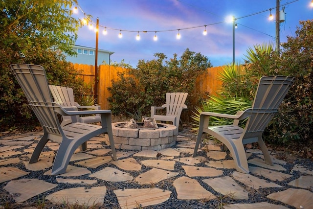 view of patio / terrace with a fire pit and fence