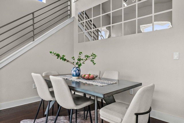 dining area featuring baseboards, wood finished floors, and a wealth of natural light