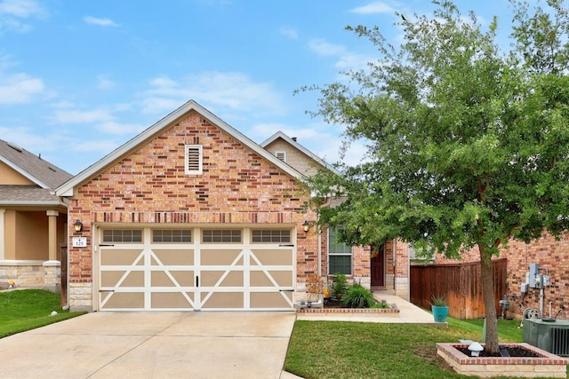 view of front facade with a garage, fence, a front yard, stone siding, and driveway