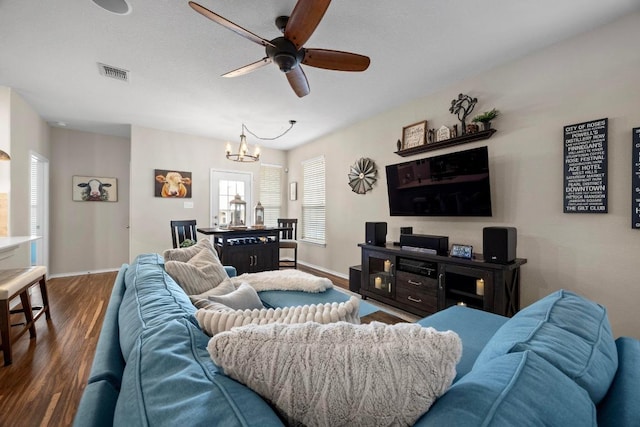 living area with baseboards, visible vents, wood finished floors, and ceiling fan with notable chandelier