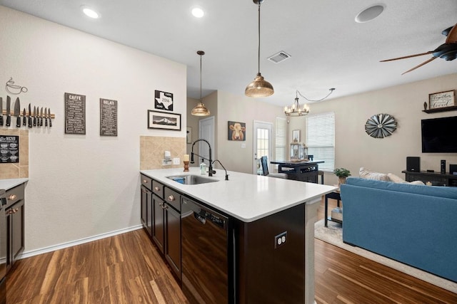 kitchen with a sink, light countertops, black dishwasher, open floor plan, and visible vents