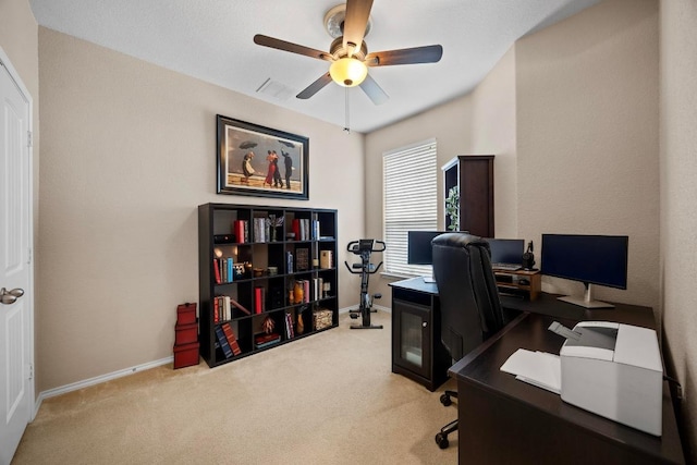 office space with carpet floors, baseboards, and ceiling fan