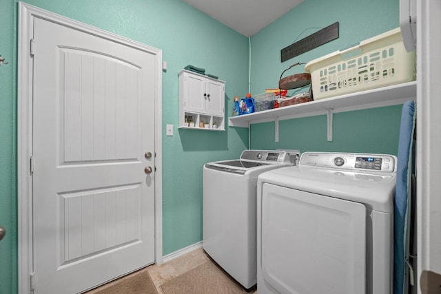 clothes washing area featuring washer and dryer, laundry area, and baseboards