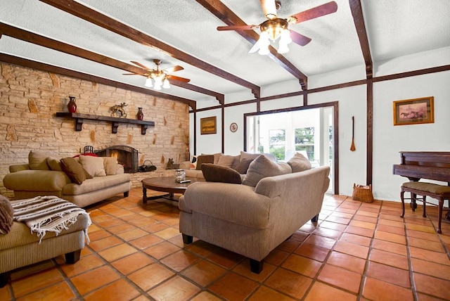 living room with a ceiling fan, a textured ceiling, beam ceiling, and tile patterned flooring
