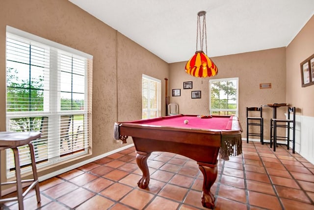 playroom featuring baseboards, pool table, a textured wall, and tile patterned floors