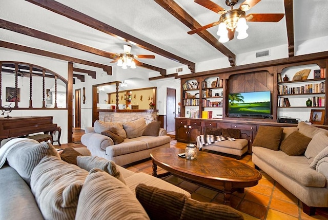 tiled living room featuring a ceiling fan, beamed ceiling, and visible vents