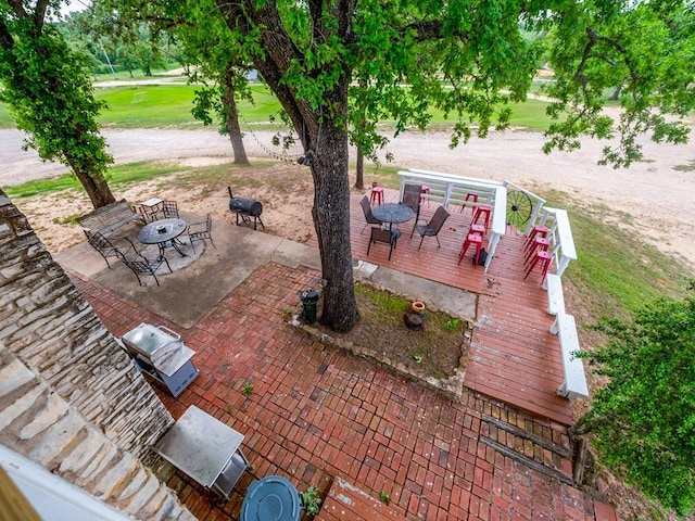 view of patio / terrace with a wooden deck and outdoor dining space